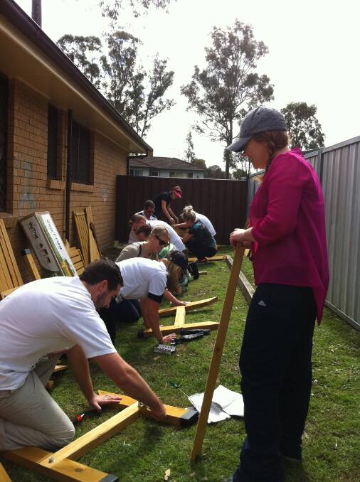HANDS-ON: Greater Building Society and PwC staff getting to work on building the project at the Youth Off The Streets drop-in centre in East Cessnock.