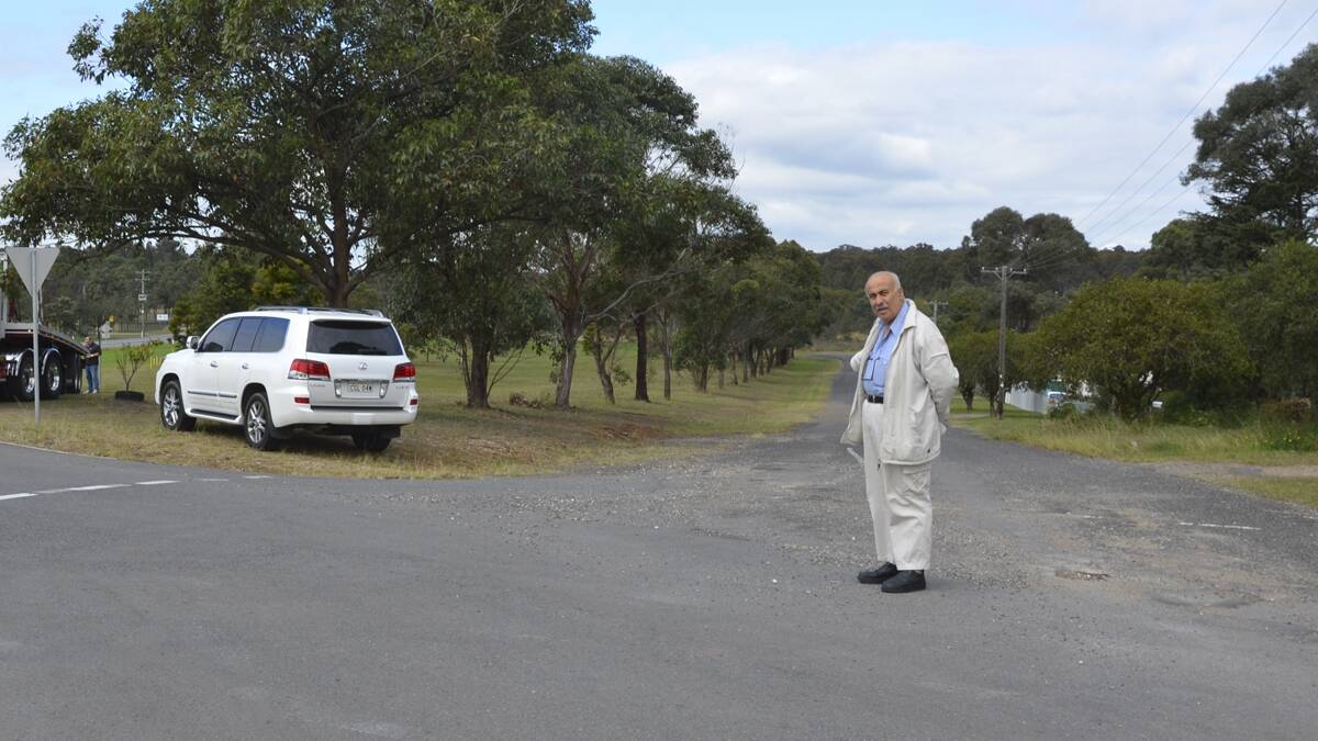 SPOT THE DIFFERENCE: Greta Metro Service Station owner Michael Younes at the junction of High Street and the New England Highway, where he paid for road repairs.