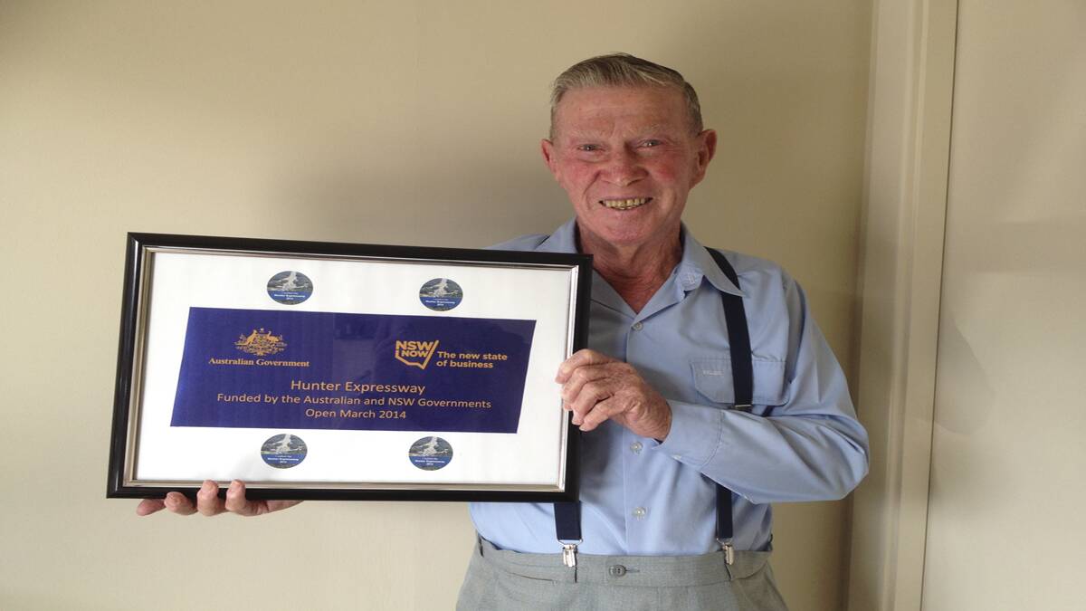 MEMENTO: Harry Hafey with a piece of the ribbon that he had framed.