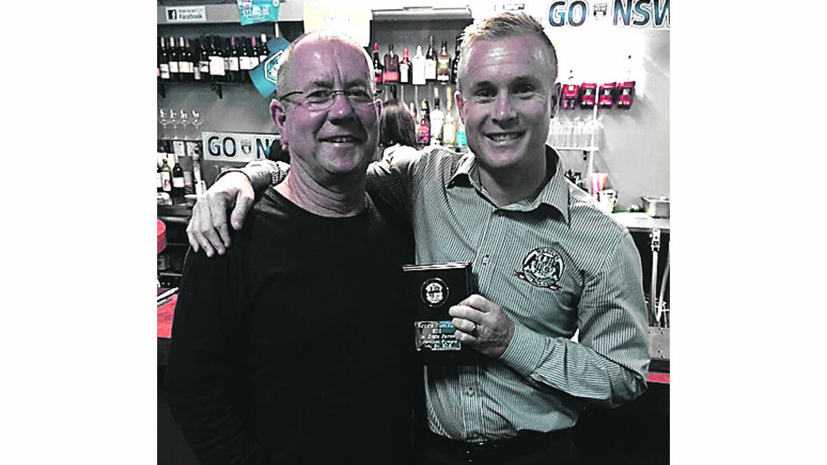 LEGACY: Robbie Turnbull with his plaque he received for his 200th game, pictured with his father Steve.
