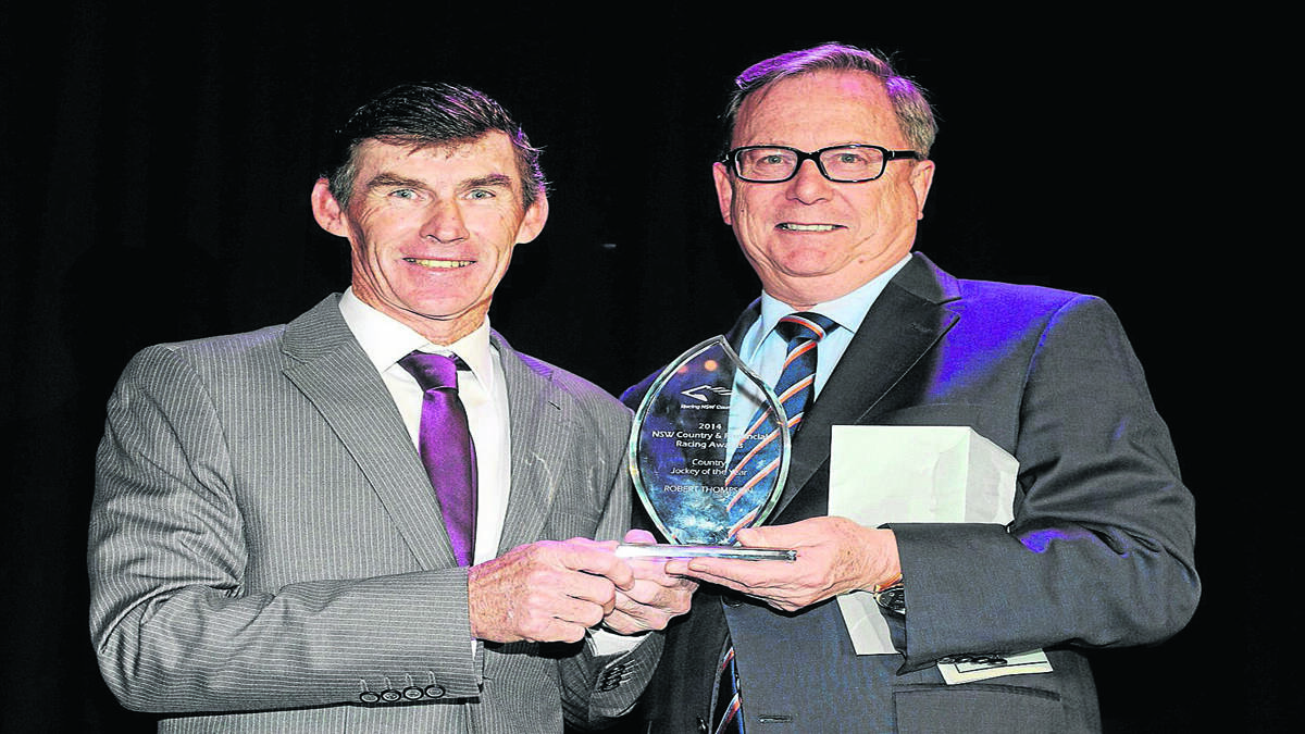 Robert Thompson receives the award from Paul Innes (CEO Australia Jockeys Association). Photo by Steve White. 