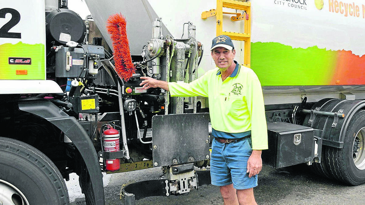 NEW TECHNOLOGY: Cessnock City Council waste truck driver Allan Bailey, with one of the trucks that have been fitted out with a FleetMax GPS camera system.
