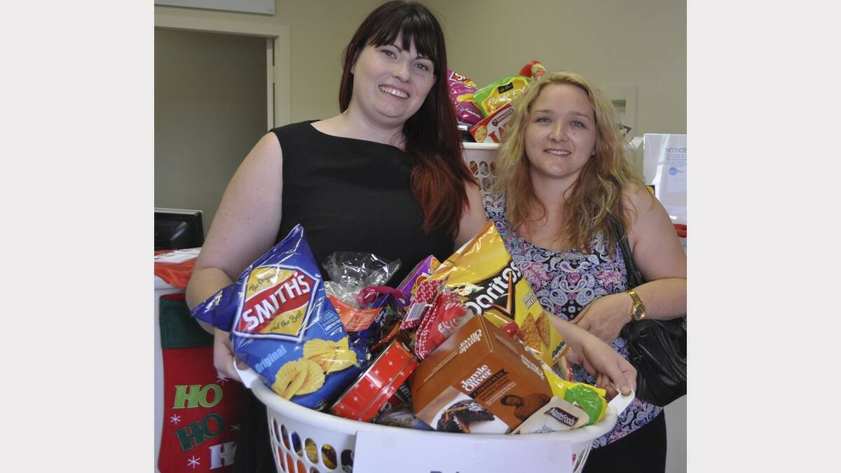 GREAT PRIZE: Brett Bartley's wife Simone (right) collects their Christmas hamper from Advertiser manager Rebecca Gillon.