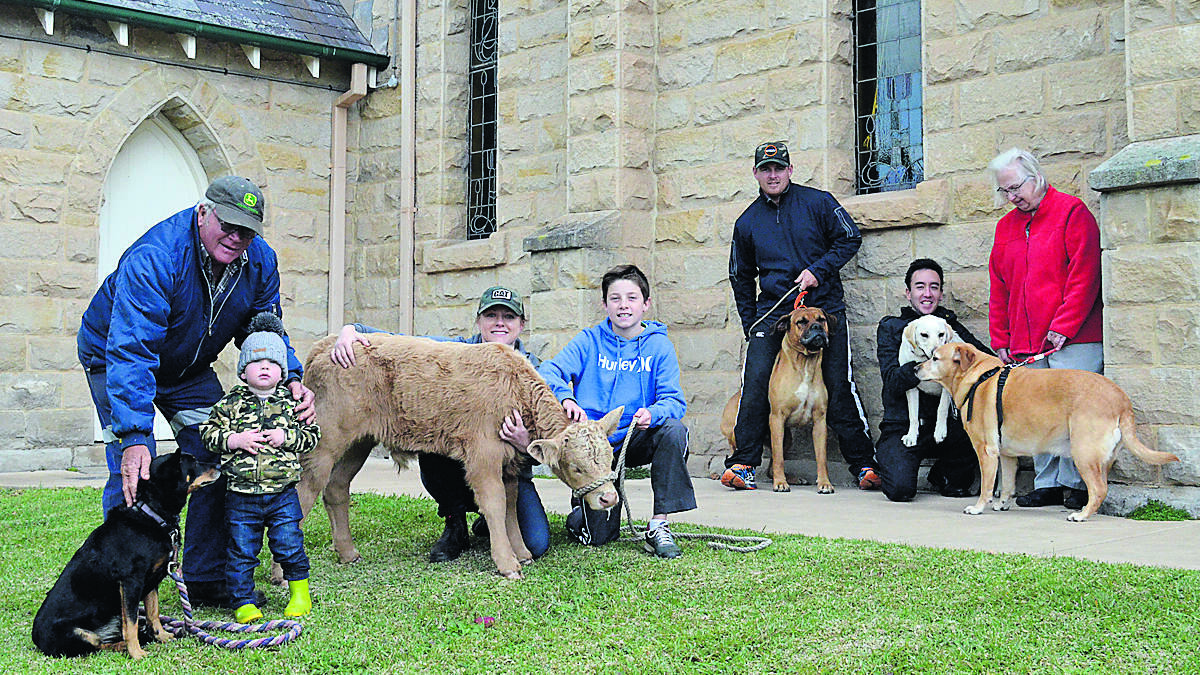 ALL WELCOME: Christ Church Mount Vincent will hold an animals’ blessing service this Sunday. Pictured at the church is Paul Latter and Clay Sheehan (with Tess), Kelly Latter and Olly Latter (with Mr T), Greg Sheehan (with Cooper), Fr Chris Jackson (with Biscuit) and Kathy Gilshenen (with Isis).