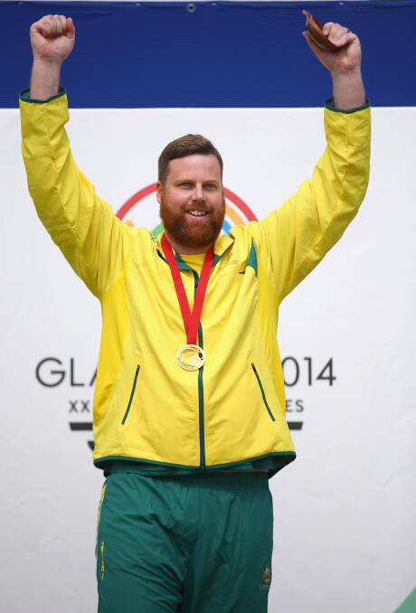 WINNER: Daniel Repacholi on the dais after winning gold in the men’s 10-metre air pistol at the Commonwealth Games on Saturday. Photo: Getty Images.