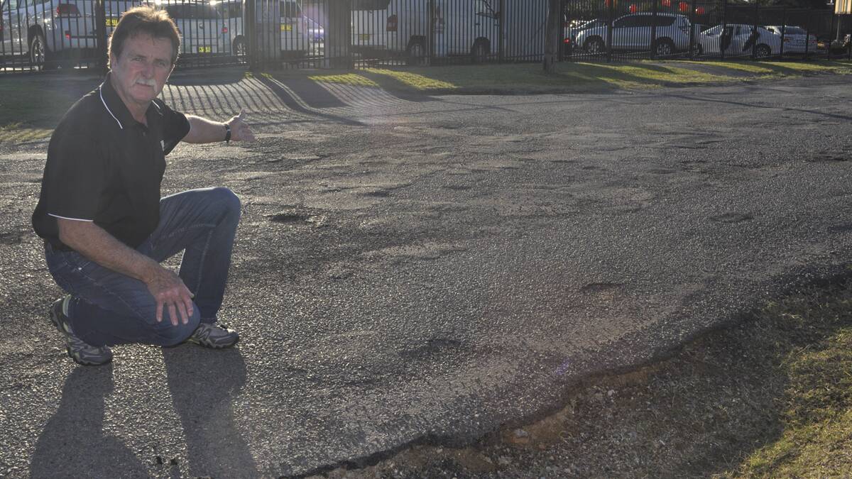 GOAT TRACK: Ken Harris inspects the pot holes in Gallagher Street, Cessnock. Photo by Sage Swinton.