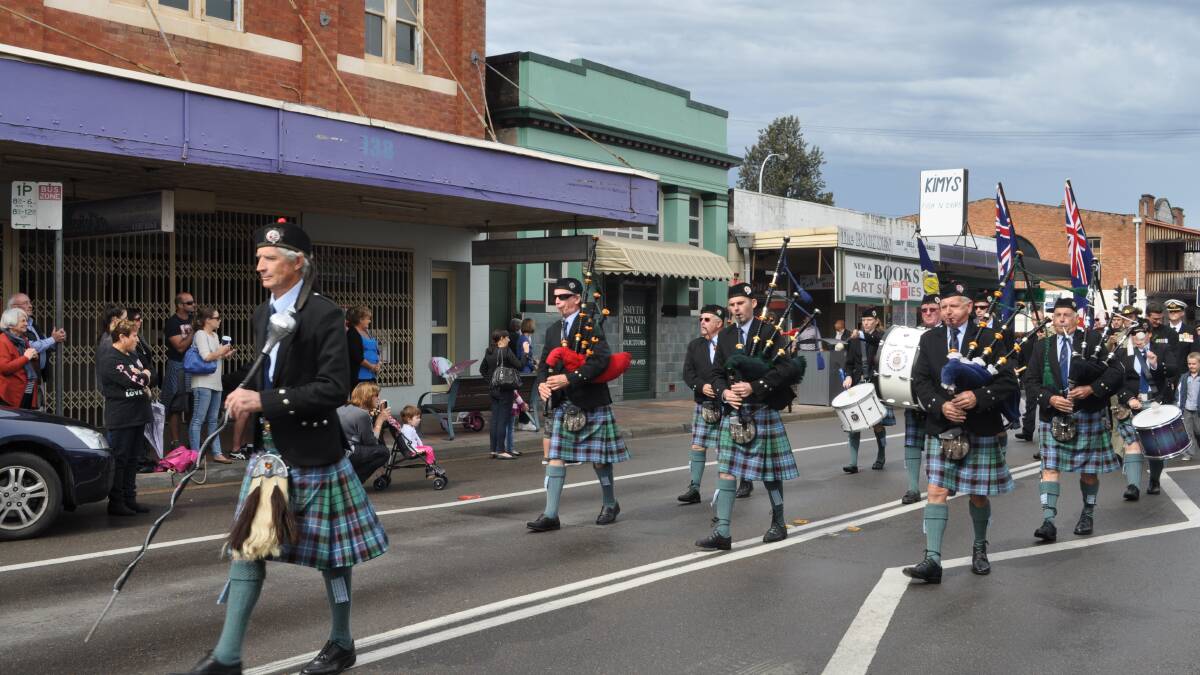 The Cessnock City RSL Pipes and Drums band makes its way down Vincent Street during the Anzac Day march.