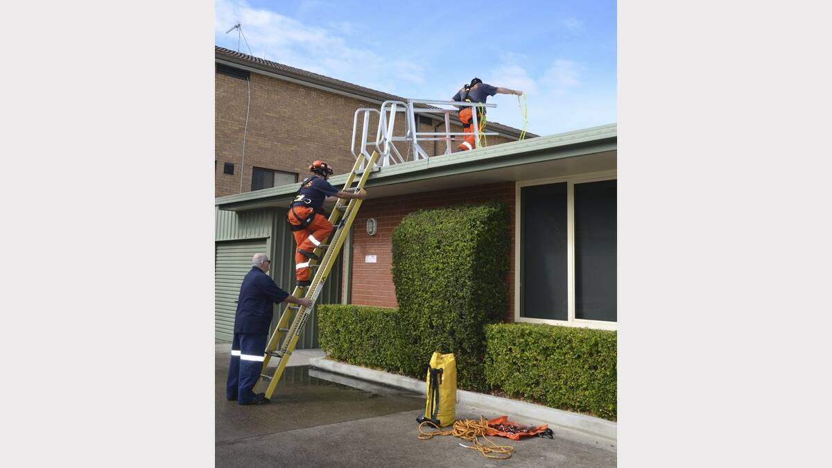 HELP: SES volunteers check on a building in Vincent Street, Cessnock on Thursday.