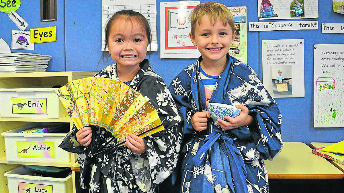 LEARNING: Kindergarten students Emily Robinson and Noah Cox celebrating Harmony Day at Abermain Public School.