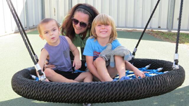 PLAY TIME: Hunter Prelude teacher Michelle Henry with Kaiden Jameson and Bailey Dumbrell, enjoying the playgrounds new swing.   