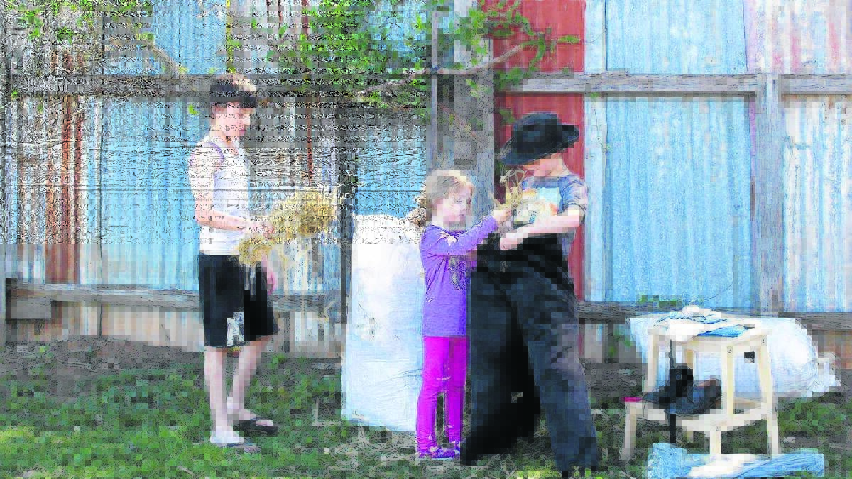 CREATIVE: Daniel, Charlotte and Nathan Avery working on their entry for Paxton Public School’s scarecrow competition, which will be judged at the school’s country fair this Friday.