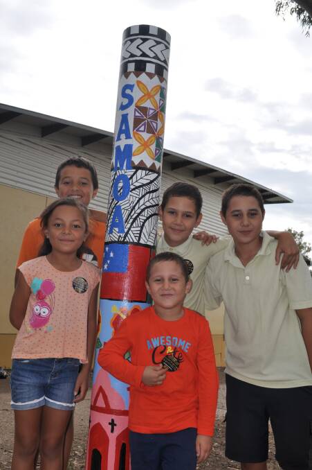 FAMILY: Students (back row)Elijah Faalua, John and Toupo Denniss and (front) Amelia Faalua and Farani Denniss with the school’s Samoa totem pole. 