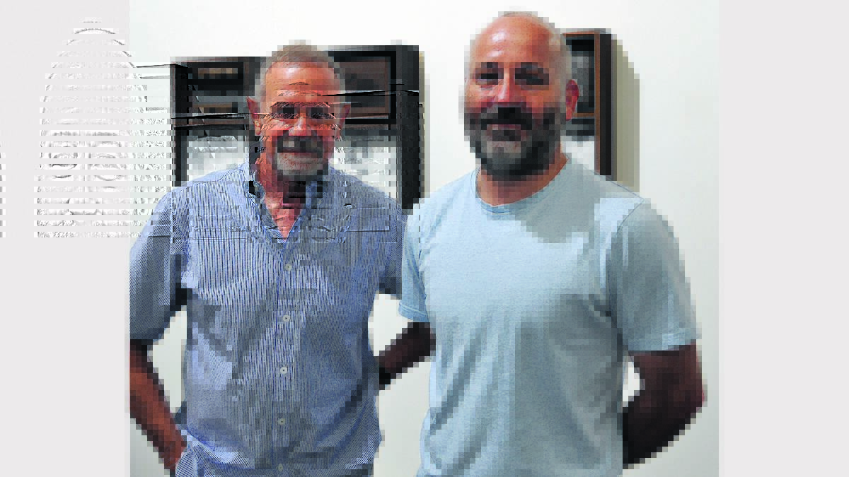 COLLABORATION: Artists Peter Tilley and Andy Devine at the opening of Black Harvest at Cessnock Regional Art Gallery on Saturday.