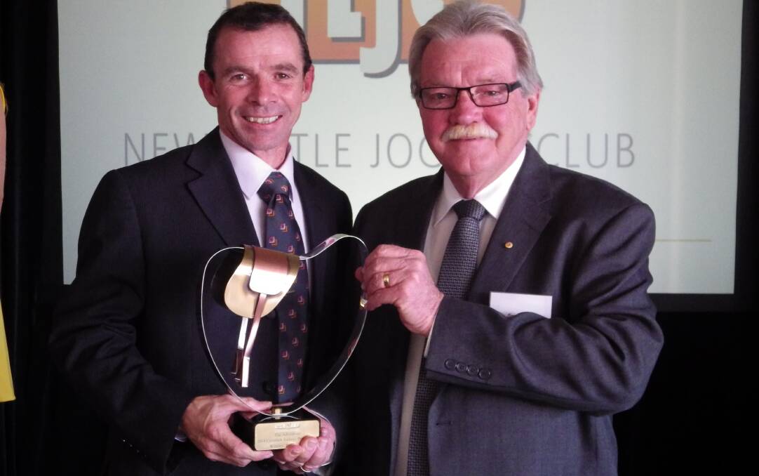 TOP JOCK: Retired editor Bruce Wilson (right)     presents The Advertiser’s trophy to the jockey’s premiership winner, Paul King.
