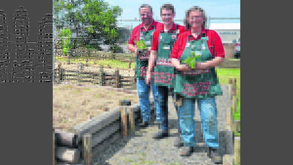 PLANTS: Bunnings Cessnock staff Graeme Champion, Cory McNeill and Cathie Charlton at the community garden at Mai-Wel.