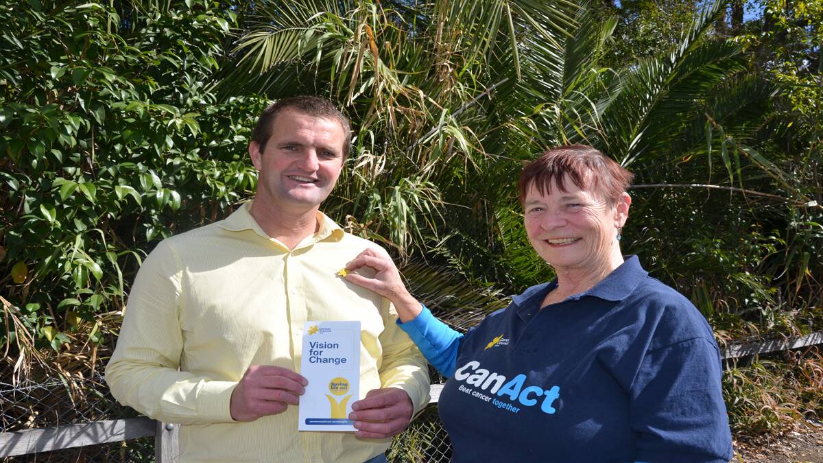 SUPPORT: Member for Cessnock Clayton Barr receiving his Daffodil Day pin from Cancer Council MP liaison Kelly Moylan.