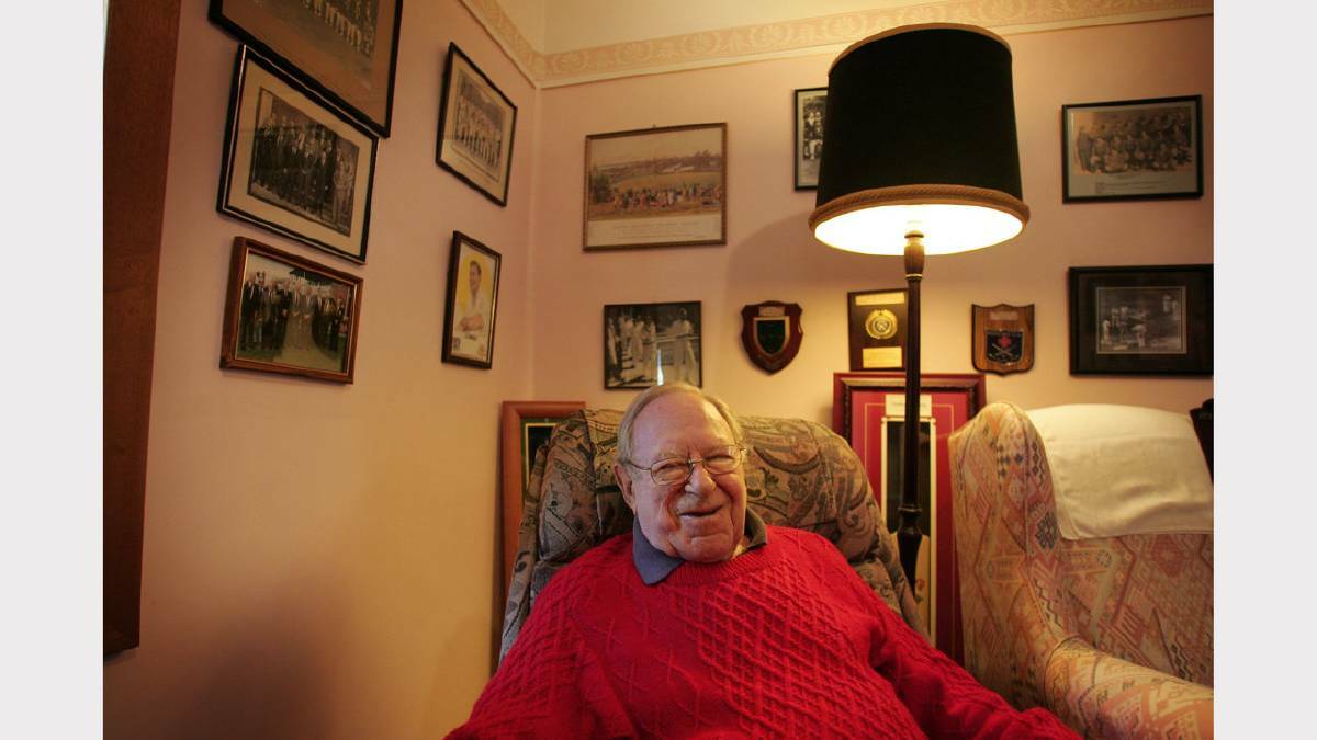 LEGEND: Arthur Morris in his Cessnock home in 2005,  with some of his memorabilia behind him. Picture by Peter Stoop.