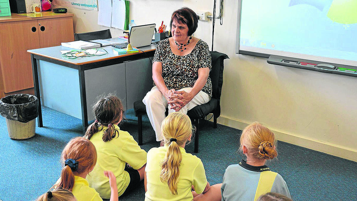 DEDICATED: Pictured at Kurri Public School, Judy West has taught special religious education in local schools for 30 years.