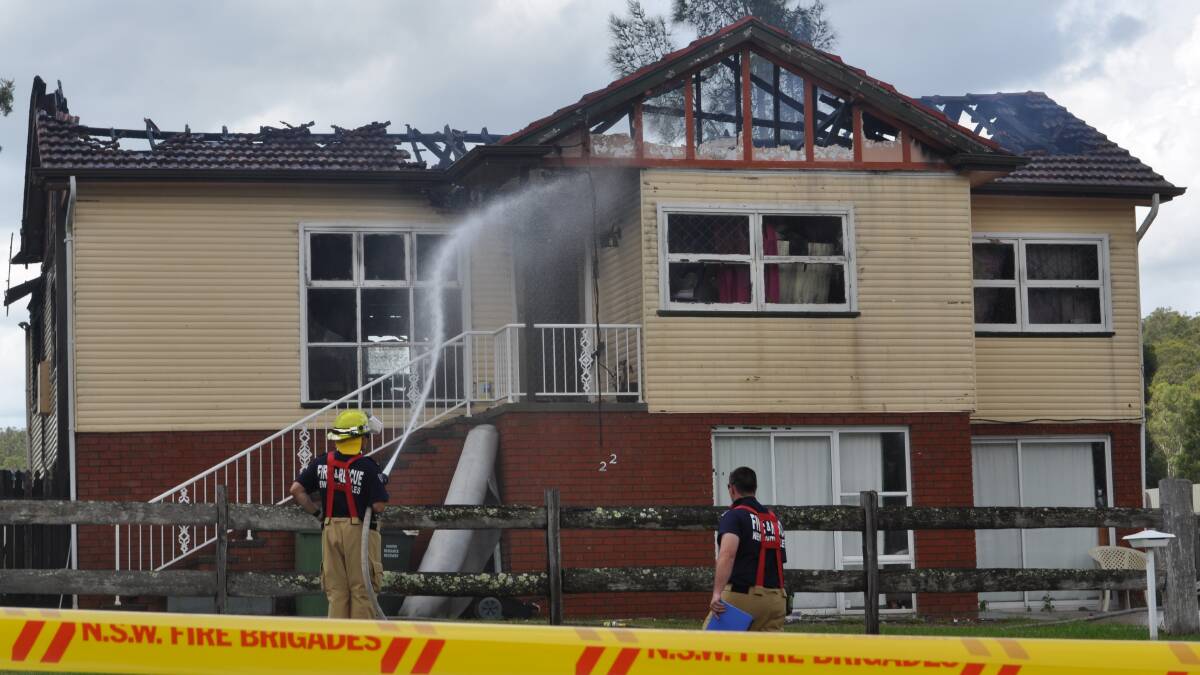DESTROYED: Firefighters work to put out the blaze at the Millfield home last Wednesday. Photo by Sage Swinton