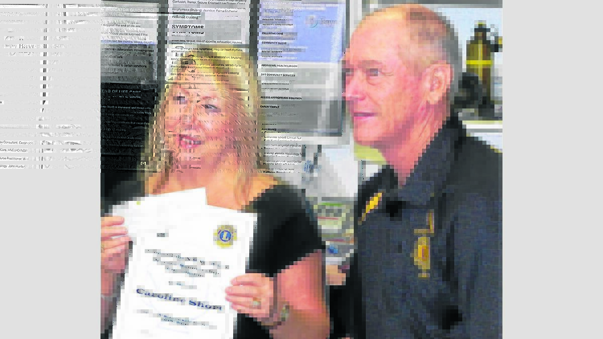 SCHOLARSHIP: Caroline Short receiving her cheque from Cessnock Lions Club president Ian Anderson.