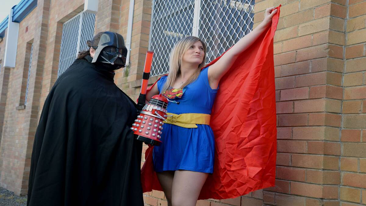 POSITIVE MESSAGE: Advertiser staff Rachel Blyth (Darth Vader) and Cassandra Battle (Supergirl) get into the spirit of National Superhero Week. 