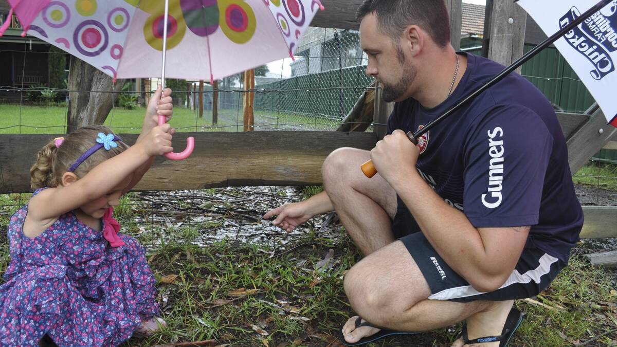 DISTRAUGHT: Brendon Clark and daughter Masani examine the hole in their fence where their bulldog Elroy was taken on Sunday morning (January 18).