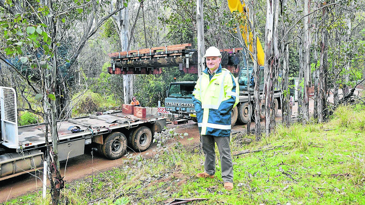 ACCESS: Council engineer Peter Davis overseeing craning in of the new bridge structure on Watagan Creek Road.