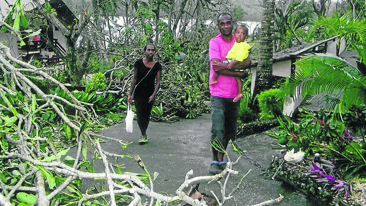 DEVASTATION: Deb and Phil Goodwin’s Vanuatu family - Cilla, Arthur and baby Jack - walk through the grounds of Fatumaru Lodge the morning after Cyclone Pam tore through the area.