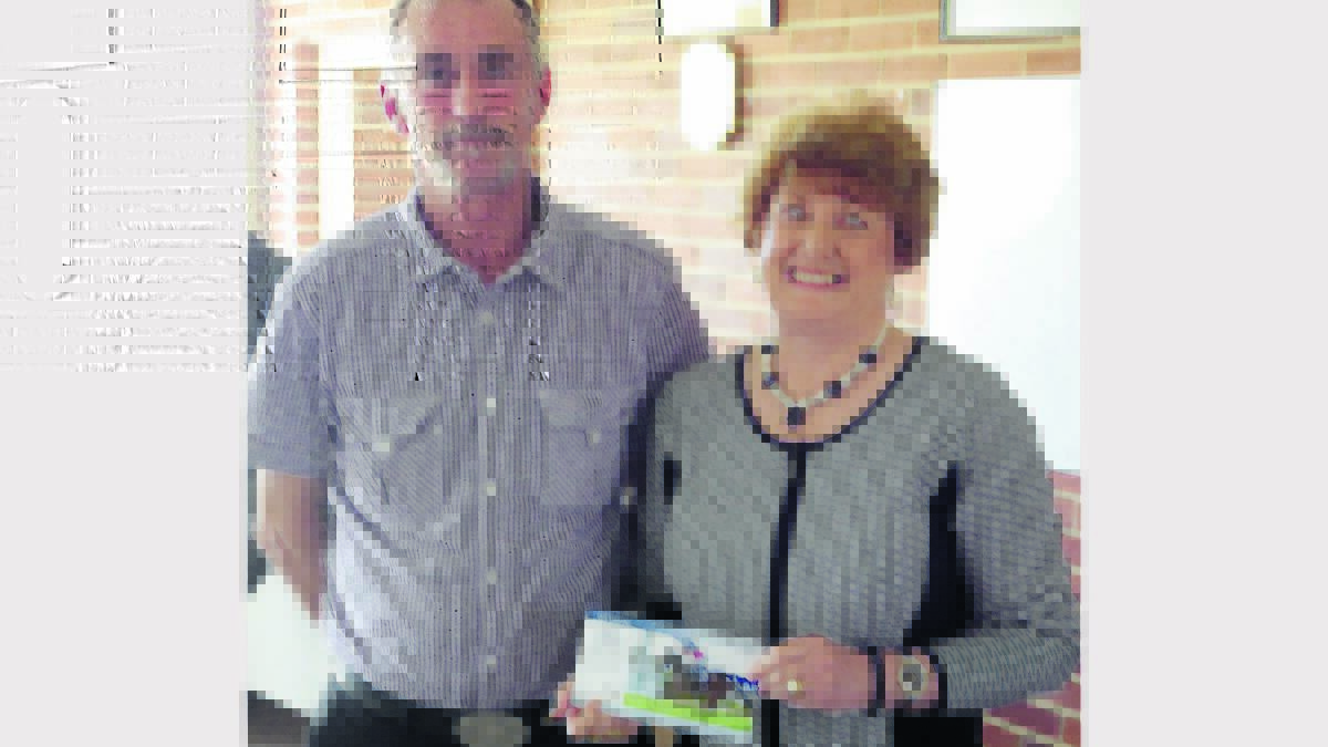TOP JOCK: Bill Kelly from the Wallabadah club presented the award for leading jockey in the Hunter and North Western Racing Association. Robert Thompson's sister Jan Burns accepted the award on his behalf.