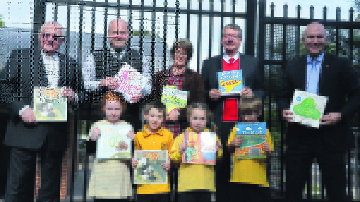 BOOKS GALORE: Back, Newcastle Permanent Charitable Foundation chairman Michael Slater, mobile lending manager Robert Whiting, author and illustrator Liz Anelli, Books in Homes chairman Brett Kingston and Newcastle Permanent Charitable Foundation executive officer Jason Bourke, and at front, Cessnock Public School kindergarten students Zoe Biggars, Jaxx Evans, Giaane Cameron and Tim Della-Santa with some of the books they received from the Books in Homes program.