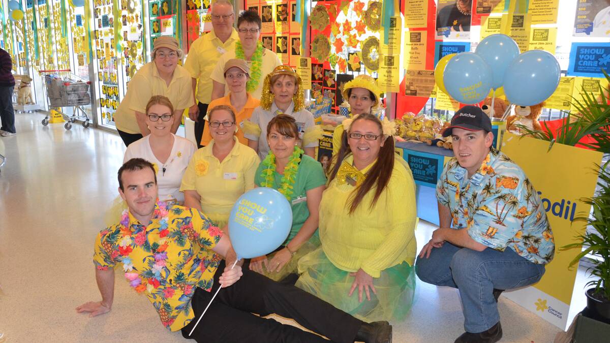 SUPPORT: Coles Kurri staff (back row, standing) Geraldine Bertoli, Garry Partridge, Mel Armstrong, (middle) Jodie Glenton, Tanya Gard­ner, Peta Glenton, (front) Bec Johnston, Rochelle Fullick, Julie Timmins, Kylie Gregory, Cole Evans, and (laying at front) Lachlan Thompson.