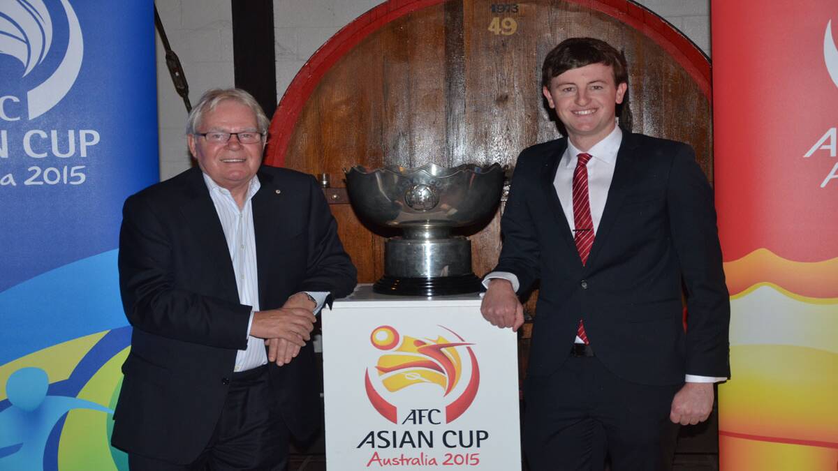 MOMENTUM BUILDS: Retired SBS sports commentator Les Murray and Cessnock councillor Morgan Campbell get up close with the Asian Cup at Hope Estate last Thursday. 