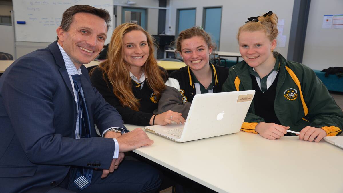 RAPPORT: Mr. Cox with Year 12 students Summer Bolton, Millie Jones and Brittany Lamb.