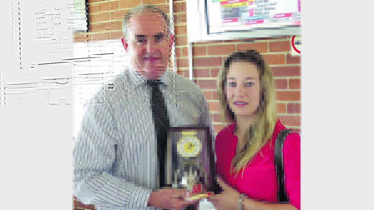 YOUNG GUN: Paul Hayes from Moree Race Club presents the leading apprentice trophy to Sophie Young who finished the season with 35 winners.