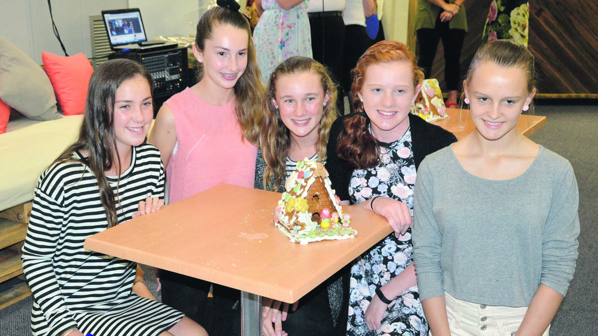 FUN: Sophie Hollis, Mackenzie Smith, Emily Whipps, Miranda Davis and Cassandra Noon won the gingerbread house decorating competition at the Cessnock Sisterhood’s Christmas Collection night.