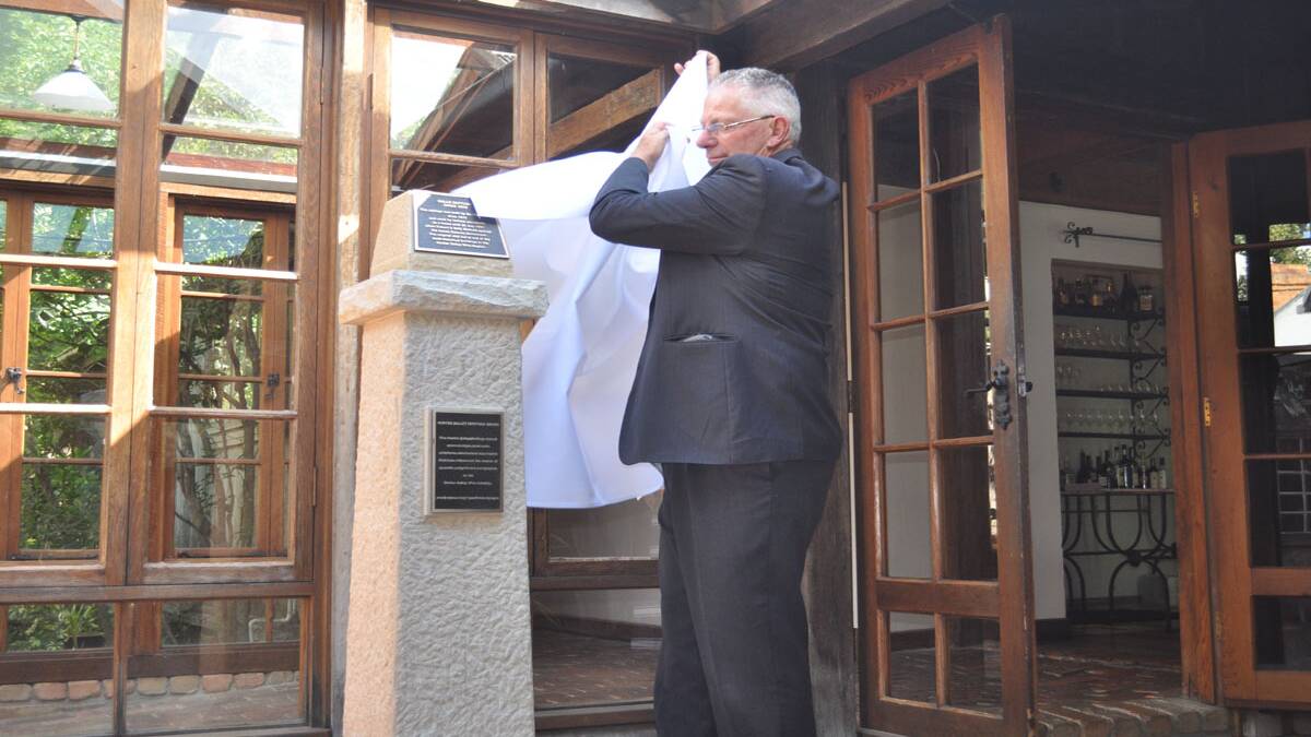 Cessnock Mayor Bob Pynsent unveils the cairn at Halls Cottage.