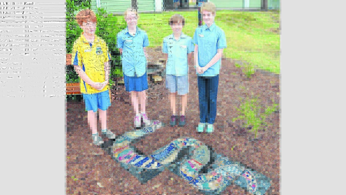 CULTURE: Mulbring Public School vice-captains Albert Wells and Sophia Bacon and captains Joshua Bacon and Lucy Bacon, with the rainbow serpent mosaic that features in the school’s new bush tucker garden.