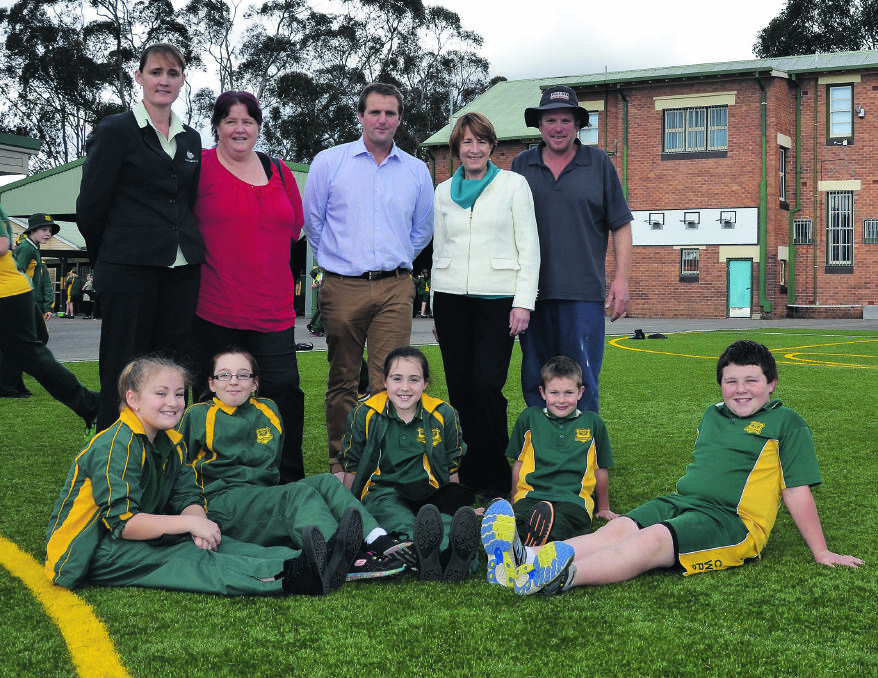 EXCITED: Pictured on the new synthetic lawn at Cessnock West Public School is (back)   P&C president Christine Boyd, treasurer Sharon Barrett, Member for Cessnock Clayton Barr, principal Ruth McGlashan and secretary Ian Glover with (front) students Abby Wade, Sienna Newsome, Caitlin Boyd, Jack Cummins and Lachlan Rees. 