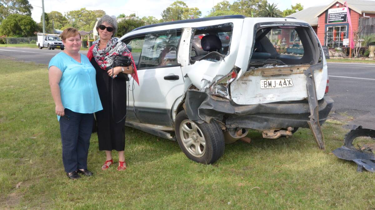 Sue Redmayne and Bernadette Thomas in front of Ms Thomas's car, which was struck in an accident on Wine Country Drive, Nulkaba.