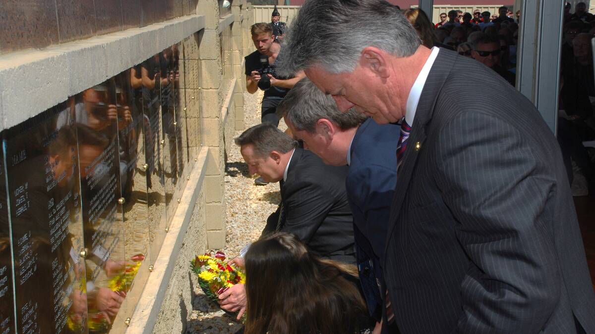 RESPECTS: Mr. Shorten and his daughter Georgette were among those who laid floral tributes at the wall. Photo by Barry Howard.