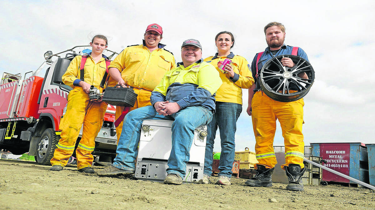 CLEAN OUT: Back, Greta Rural Fire Brigade volunteers Steph Van Herp, Mark Adam, Renee Dimech and Dylan Geipel, and at front, Balcomb Metal Recyclers owner Ed Walker who is supporting the Scrap Metal Muster at North Rothbury on Saturday. Photo by Stuart Scott.