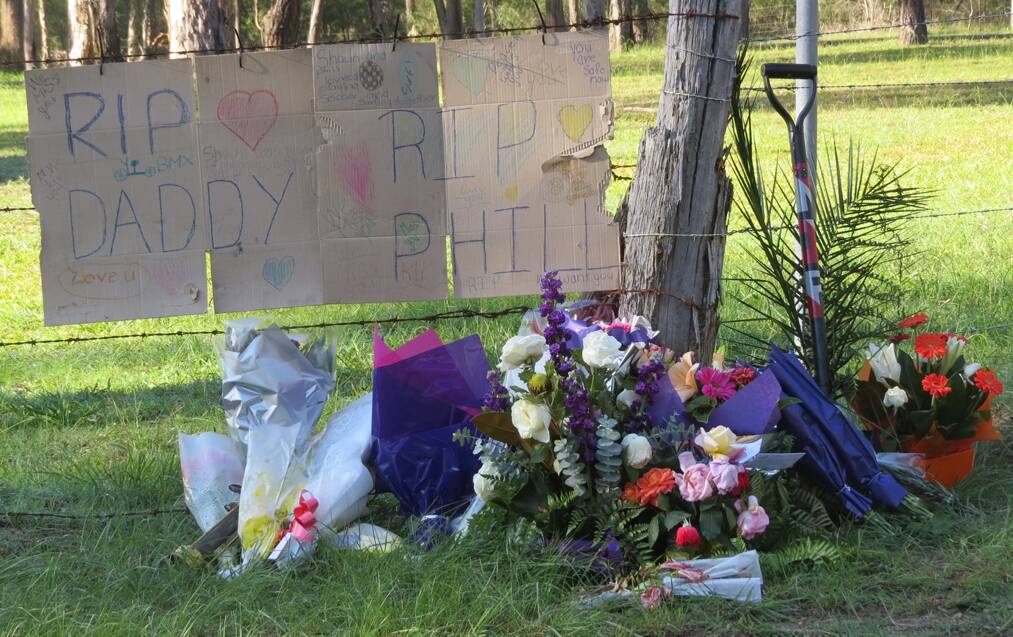 LOSS: Dozens of tributes have been left at the entry of the Paxton mine, including a sign from Phillip Grant’s son.  