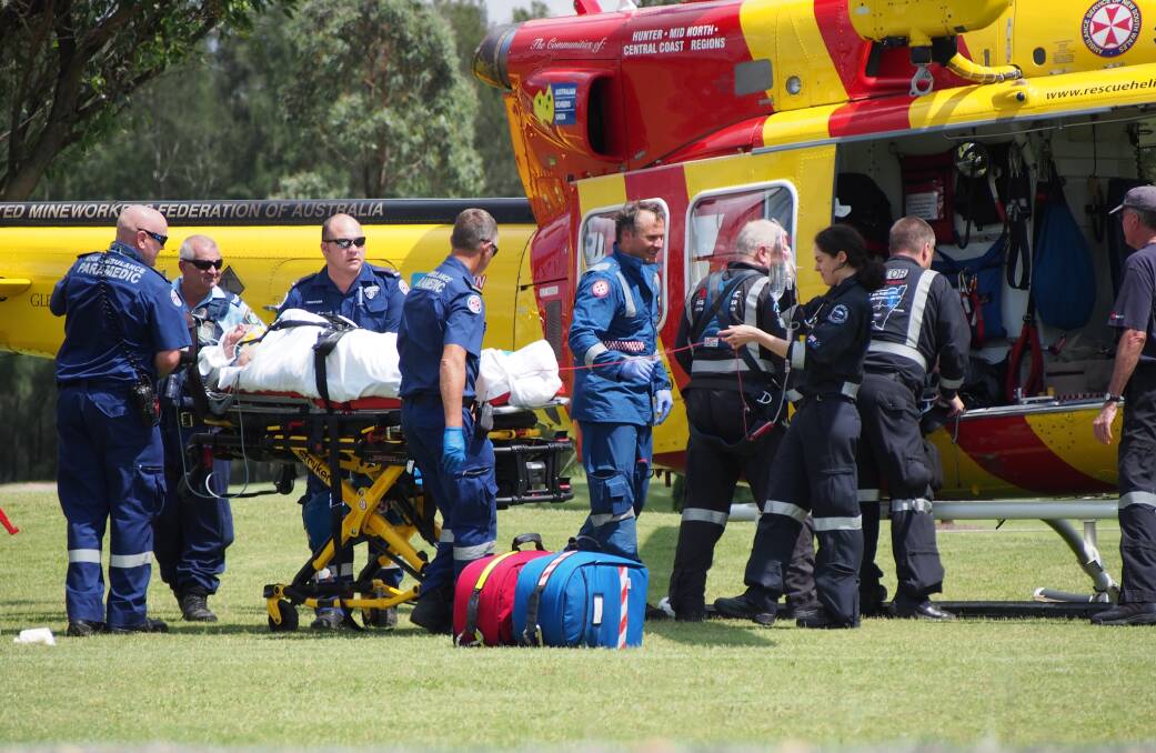 OFF TO HOSPITAL: Paramedics were on the scene quickly after the accident and the man was flown to John Hunter Hospital with suspected broken bones.   