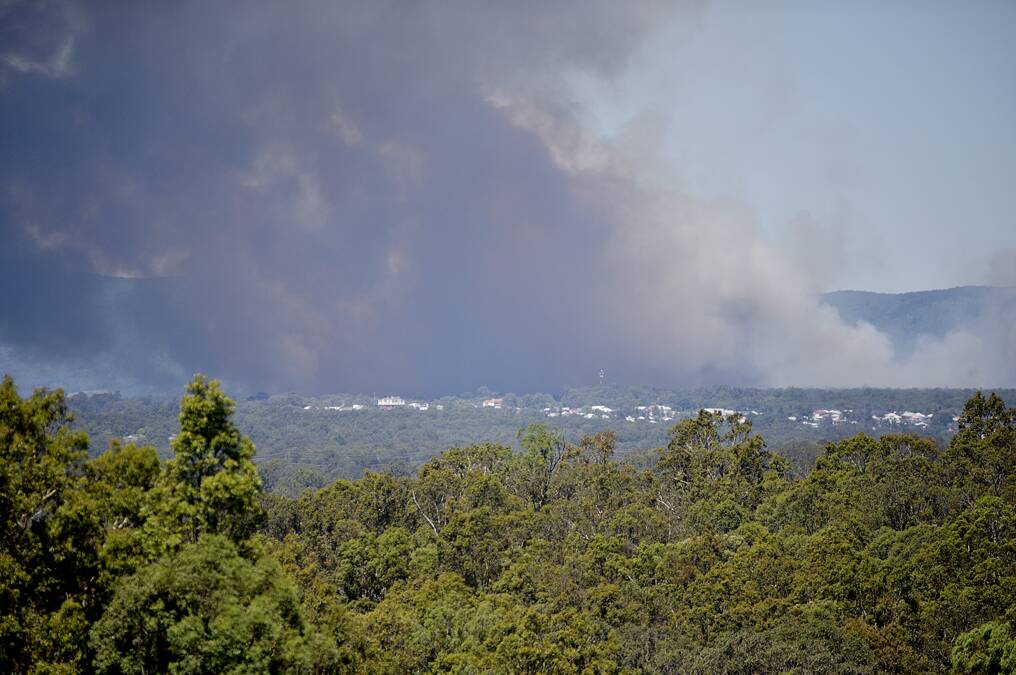 FIRE BUILDS: Smoke fills the sky above Kurri Kurri at 11.45am. Picture by CATH BOWEN