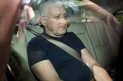 Out on ball . . . Ron Medich leaves jail yesterday. His new home in a chic city high rise includes a private 50-metre swimming pool, gym, jacuzzi and sauna.