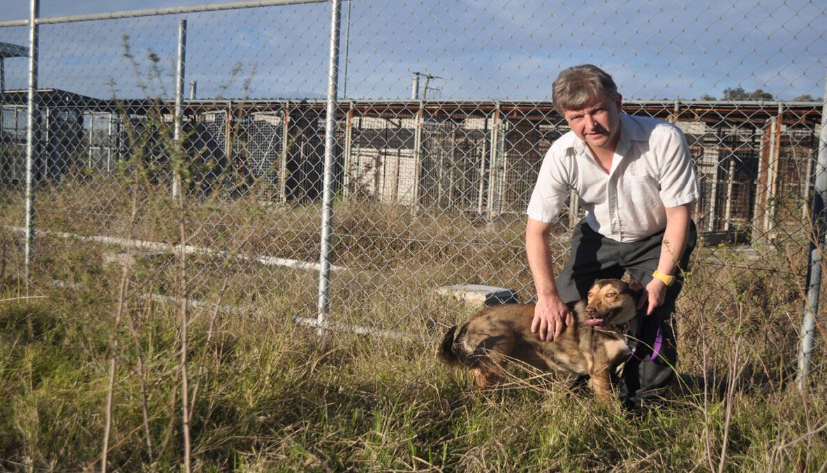 DISAPPOINTED: SoCares vice-president David Atwell and his rescue dog, Tracey, at the former Kurri Pound site.