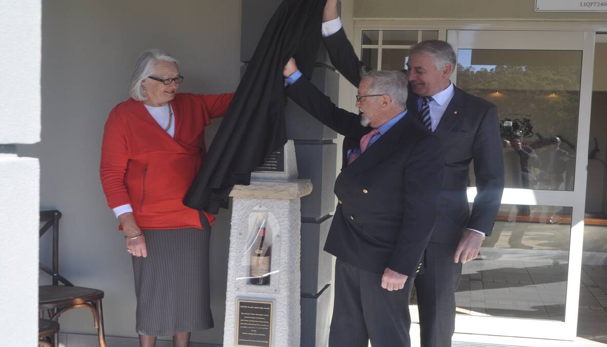 PROUD: Julie and Jay Tulloch of Tulloch family wines and NSW Tourism Minister and Member for Upper Hunter, George Souris (back), officially unveiled the Heritage Cairn acknowledging the vineyard’s Pokolbin Dry Red Label.  