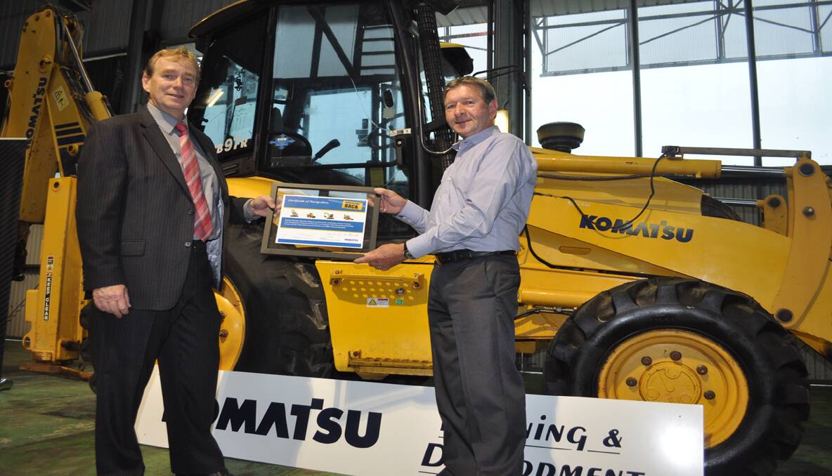 DONATION: Komatsu’s National Technical Development Manager Paul Richardson (right) presented Hunter TAFE Faculty Director Rob Wolter with a plaque commemorating the donation of the earthmoving equipment. 