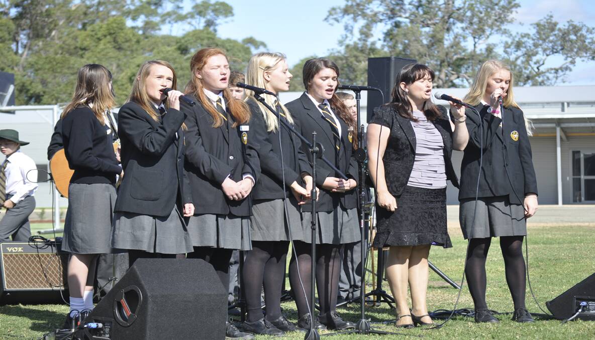 The senior girls group sings the National Anthem. 