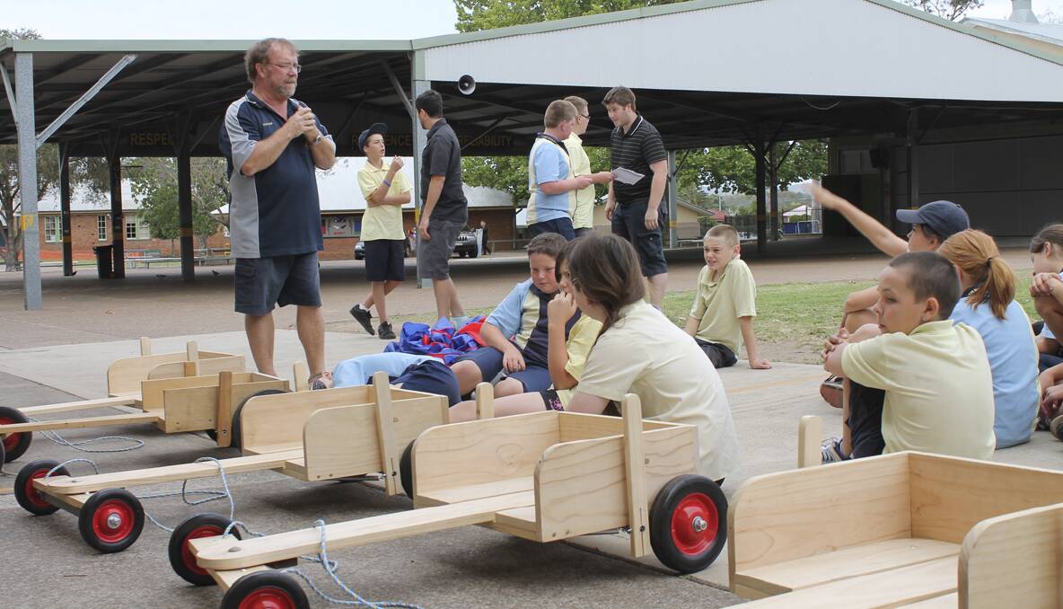 FUN: Kurri Public School students working on their entries for the billy cart derby.